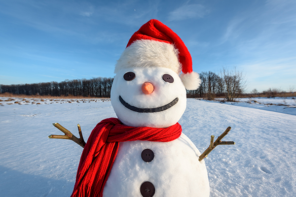 Funny snowman in red hat